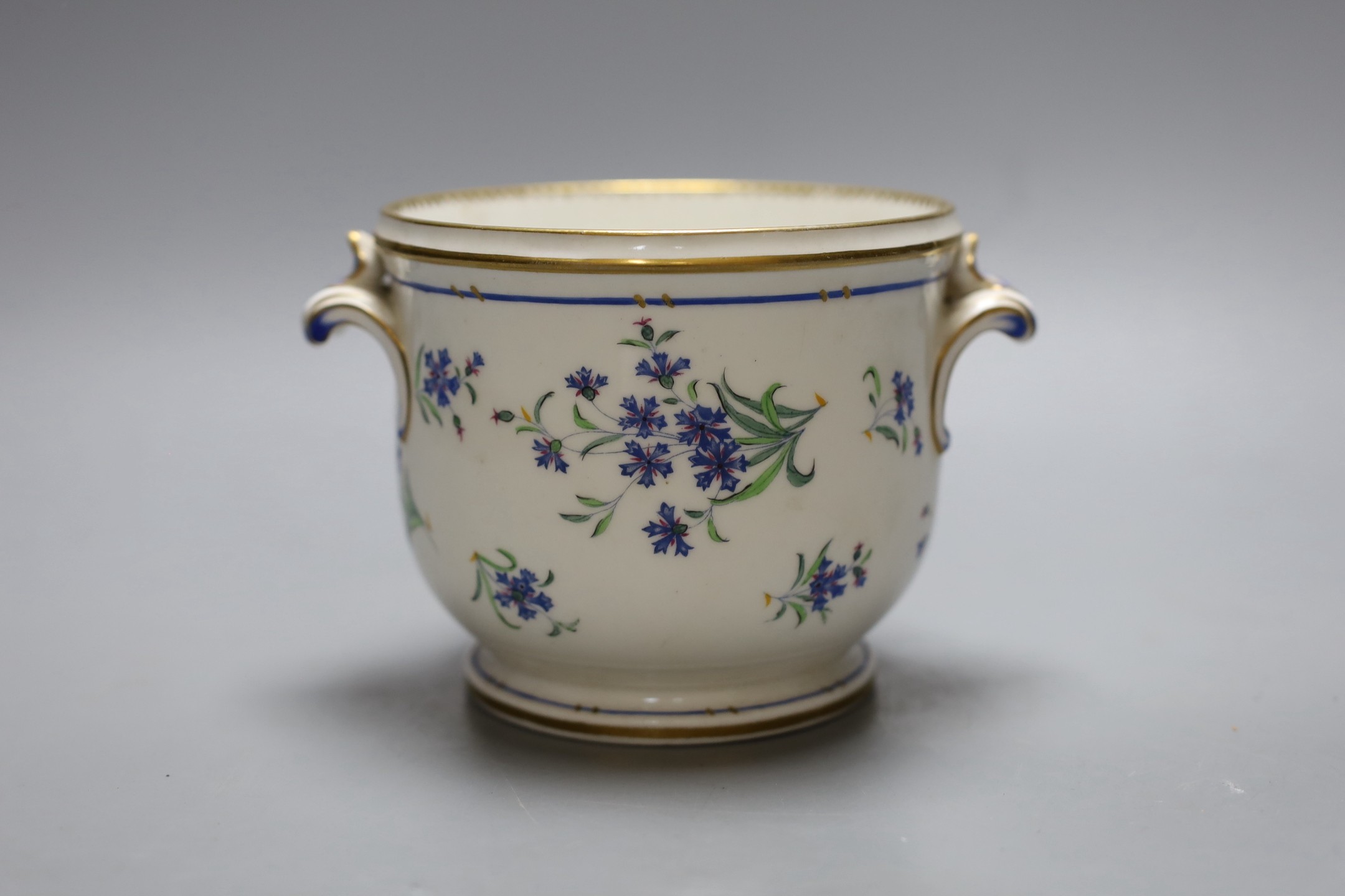 An early 19th century Paris porcelain cache pot or glass cooler with two handles painted with corrnflowers, 9.5 cms high